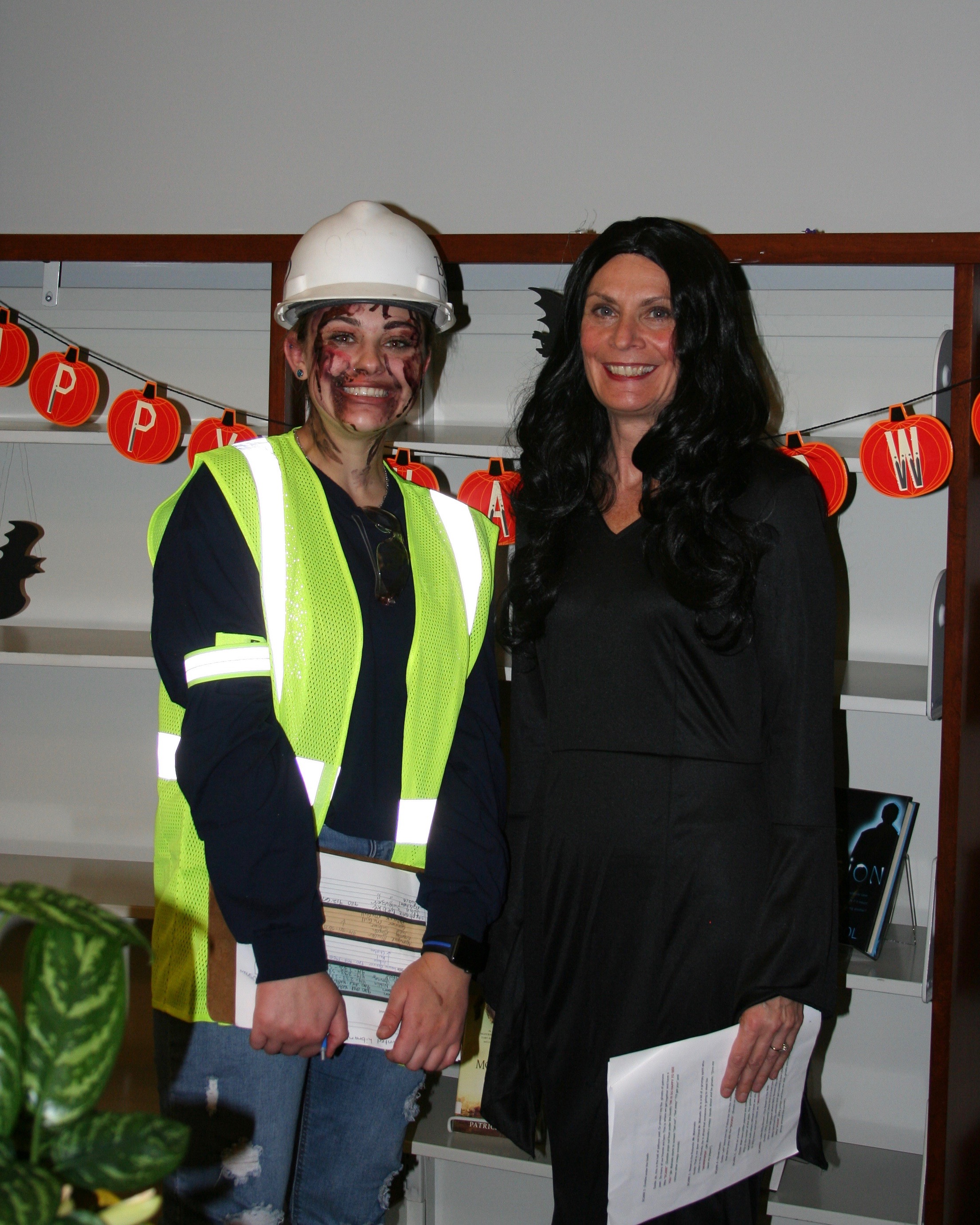 Person dressed as construction worker posing with woman at event
