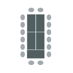 Tables pushed together to make a larger rectangle with chairs around outside edges.