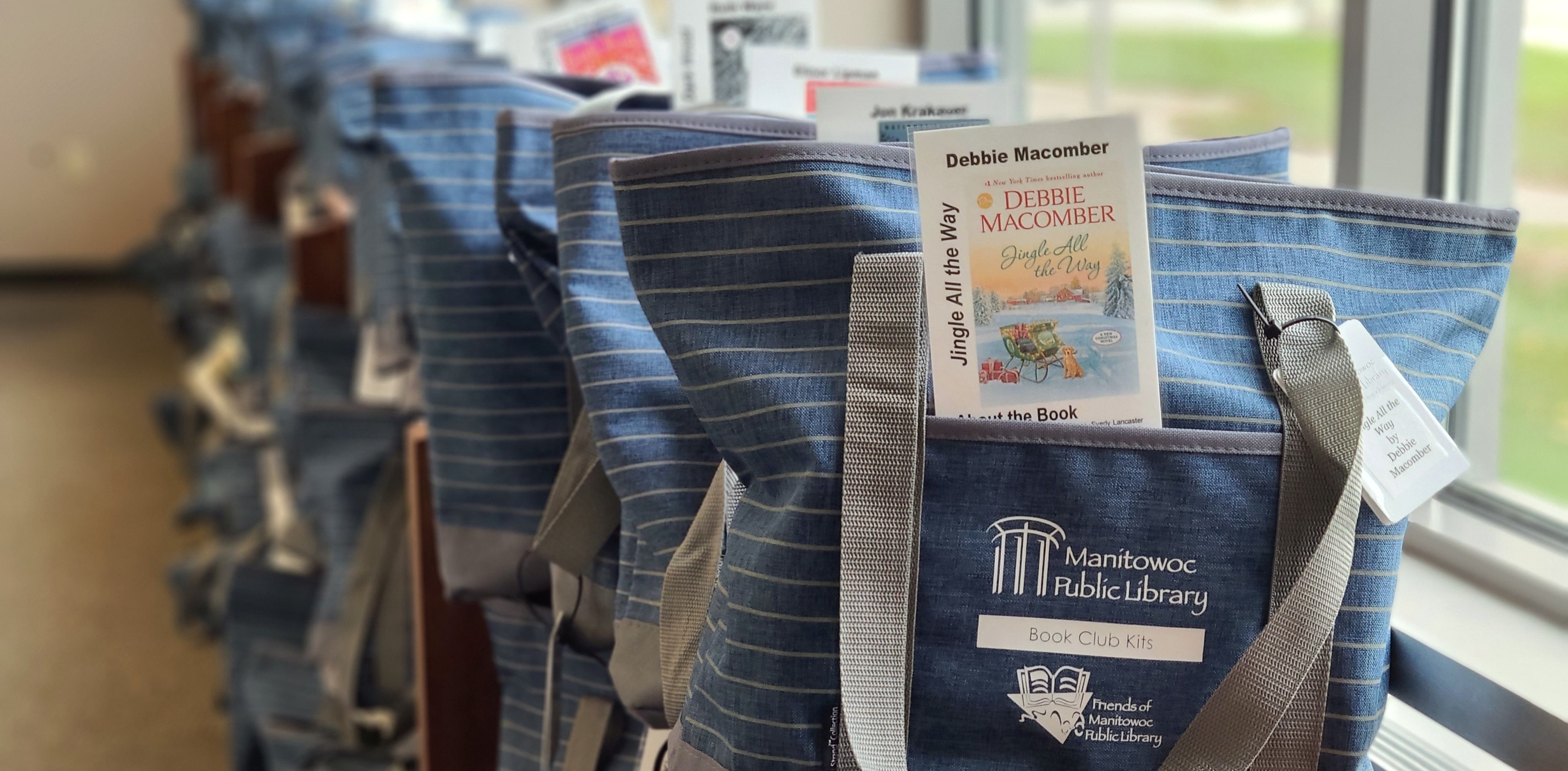 Bags of book club kits on shelf