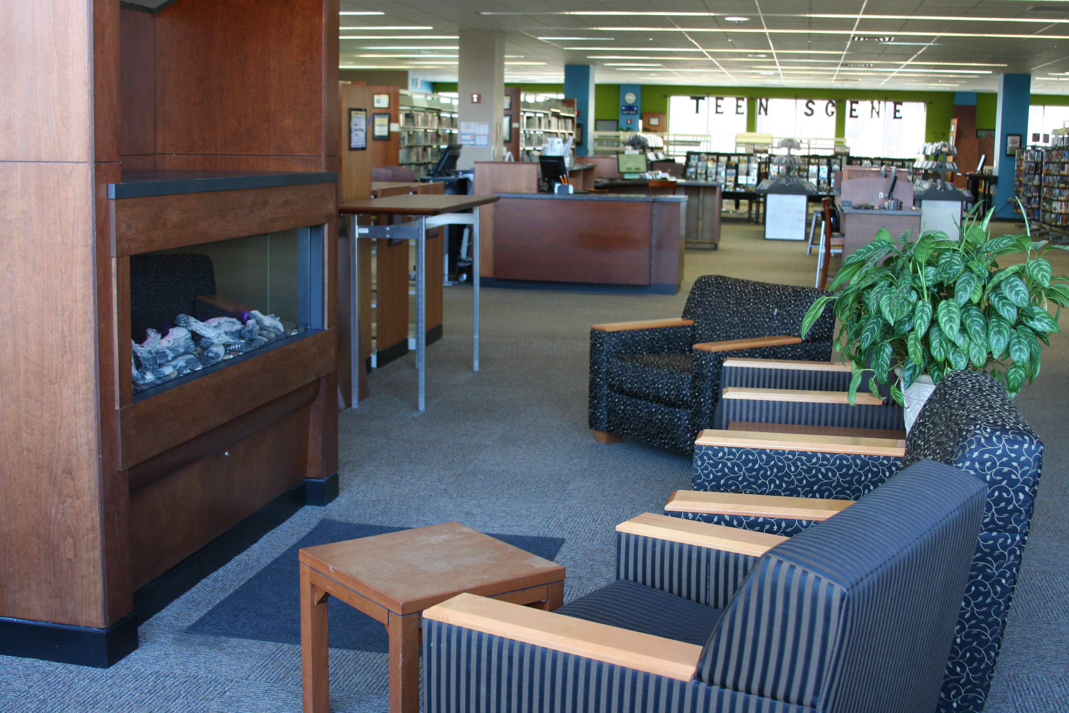 Chairs surrounding fireplace in library