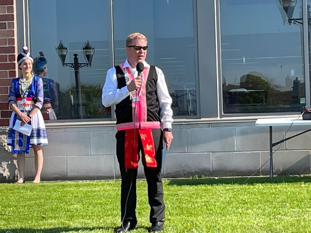 Speaker wearing traditional Hmong dress