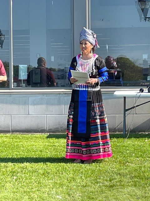 Speaker wearing traditional Hmong dress
