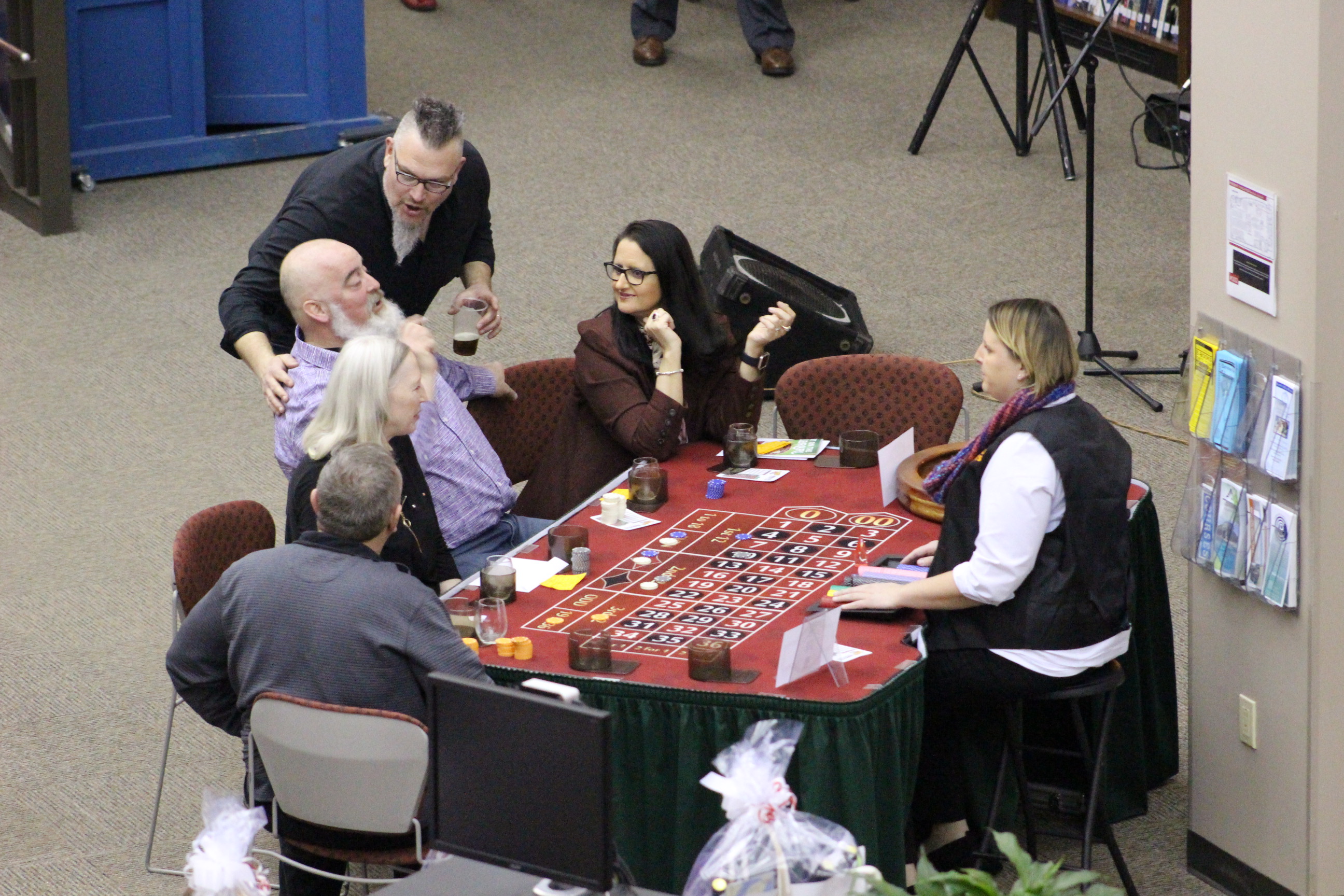 Dealer and players at casino table