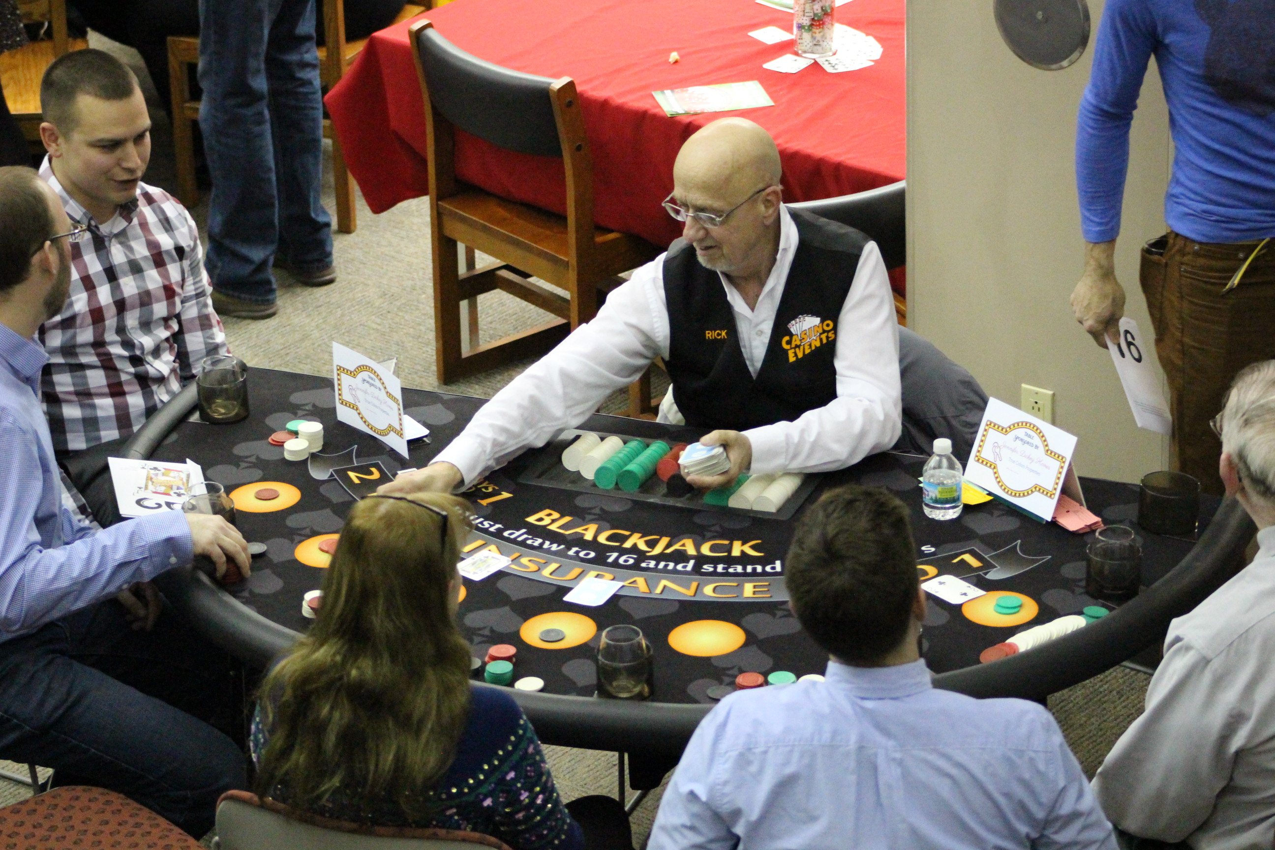 Dealer and players at a blackjack table