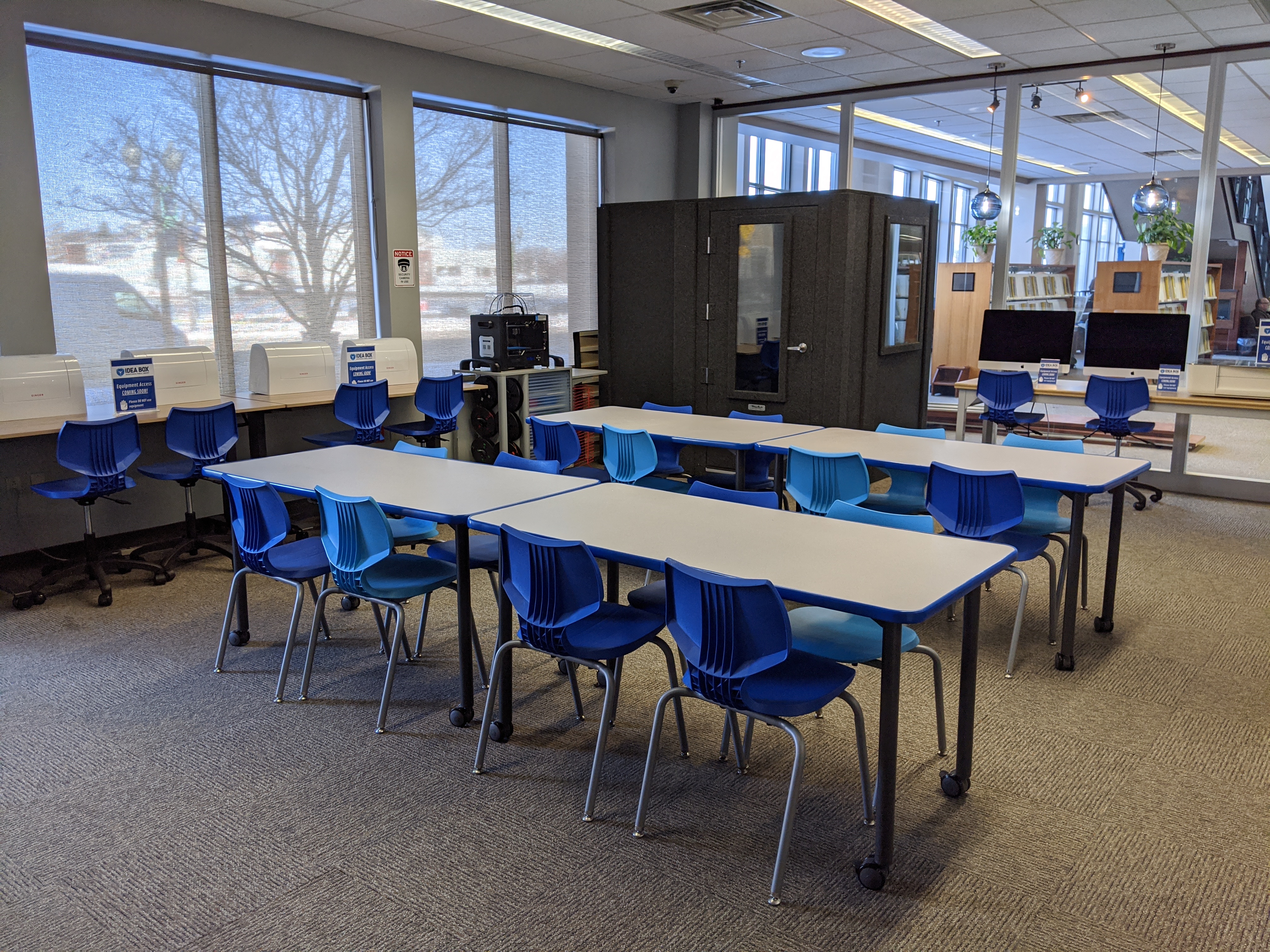 Idea Box work tables with sound booth in background