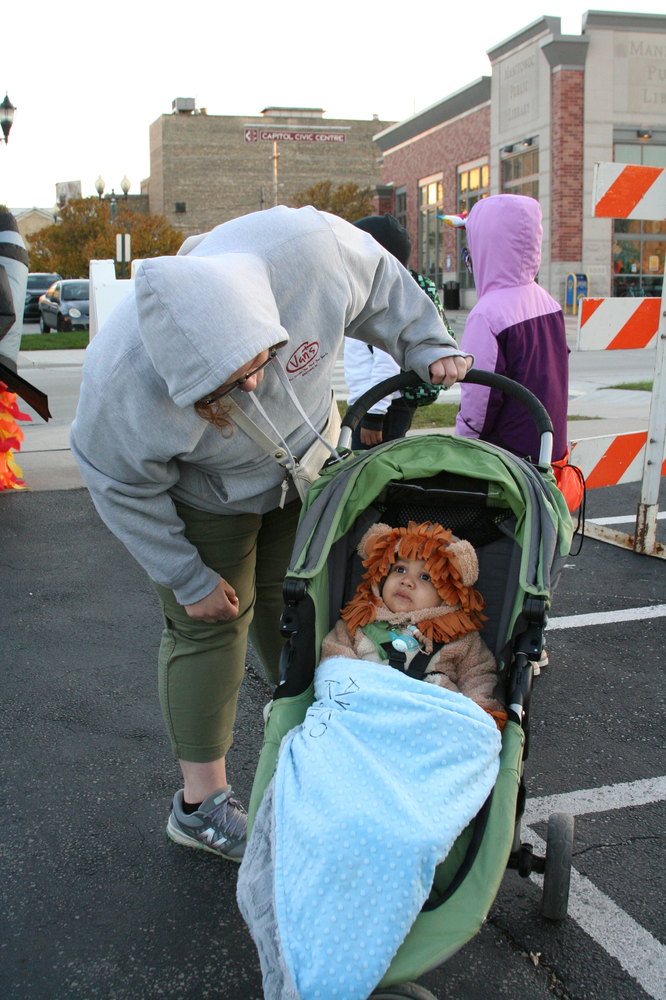 Person with costumed child in stroller