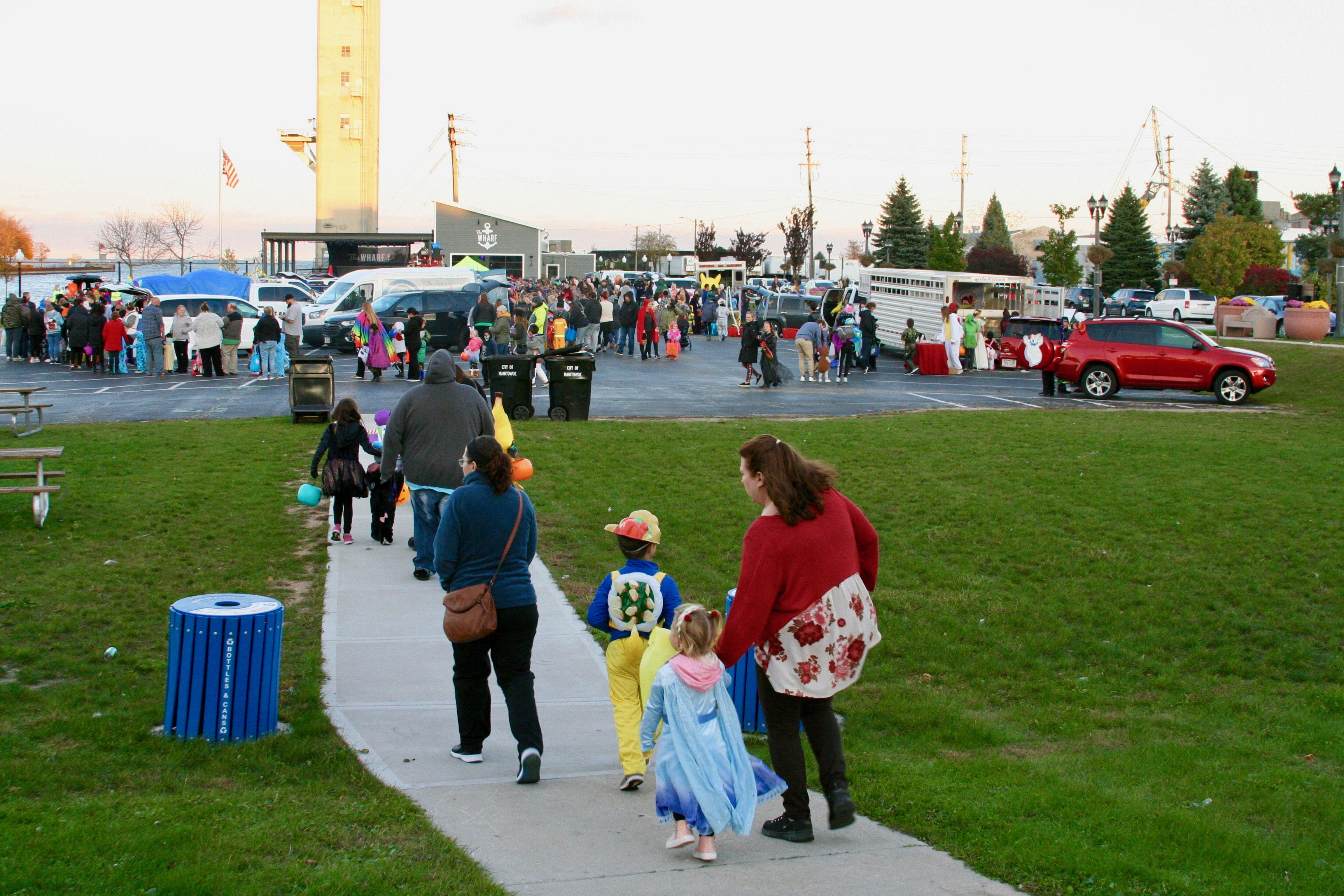 Family walking to trunk or treat event area