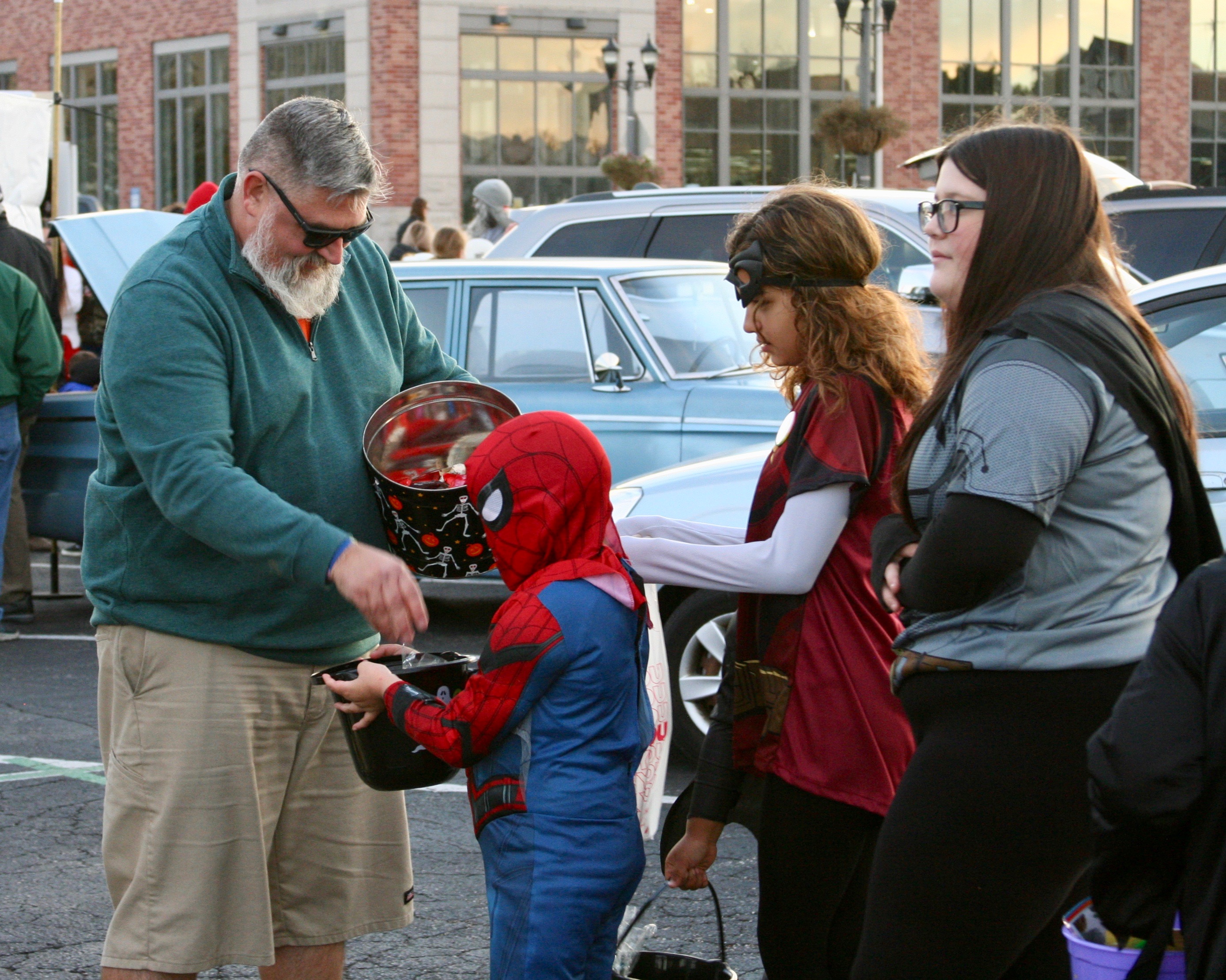 Man gives candy to child dressed as Spiderman