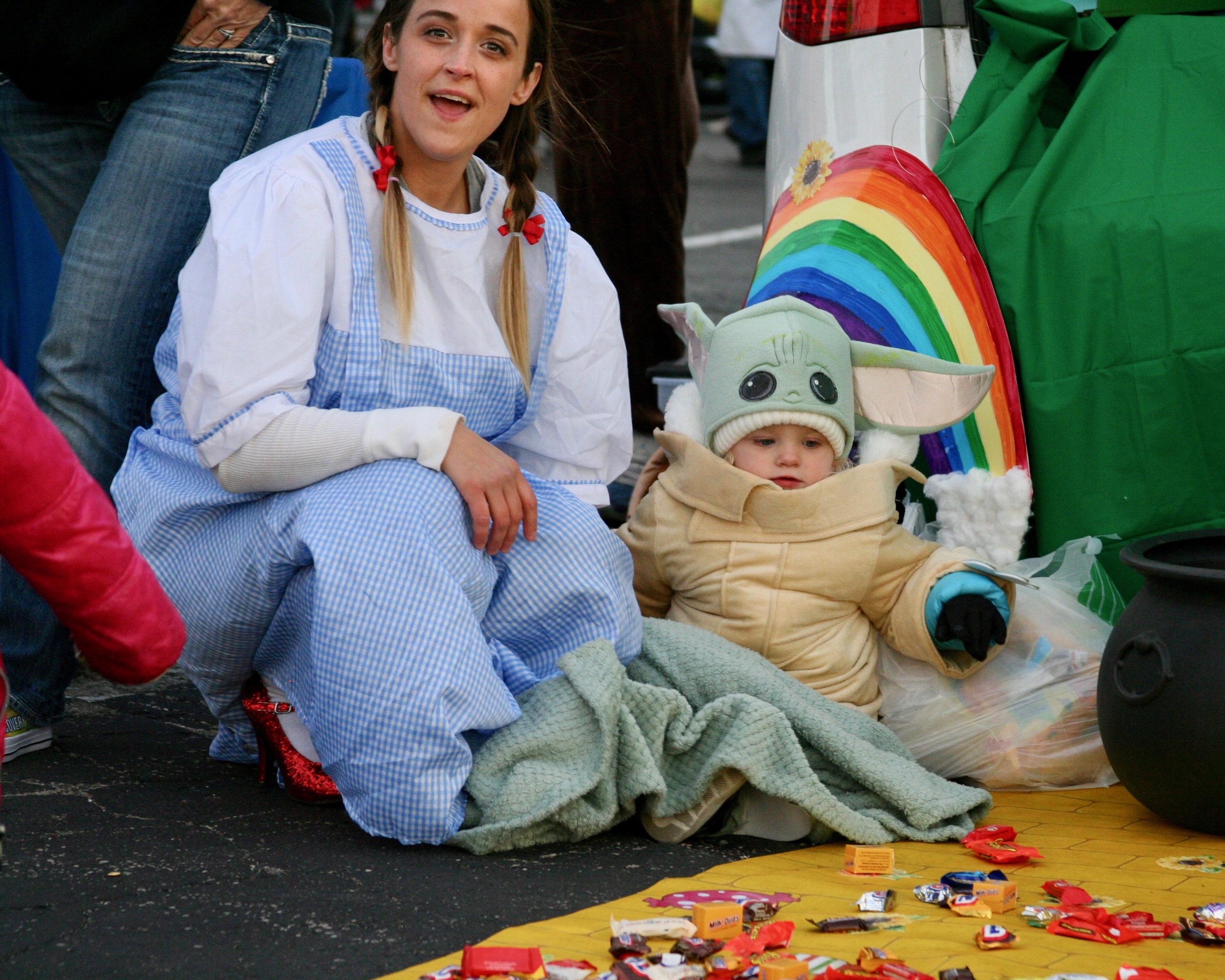 Woman dressed as Dorothy with toddler dressed as Grogu ("baby Yoda")