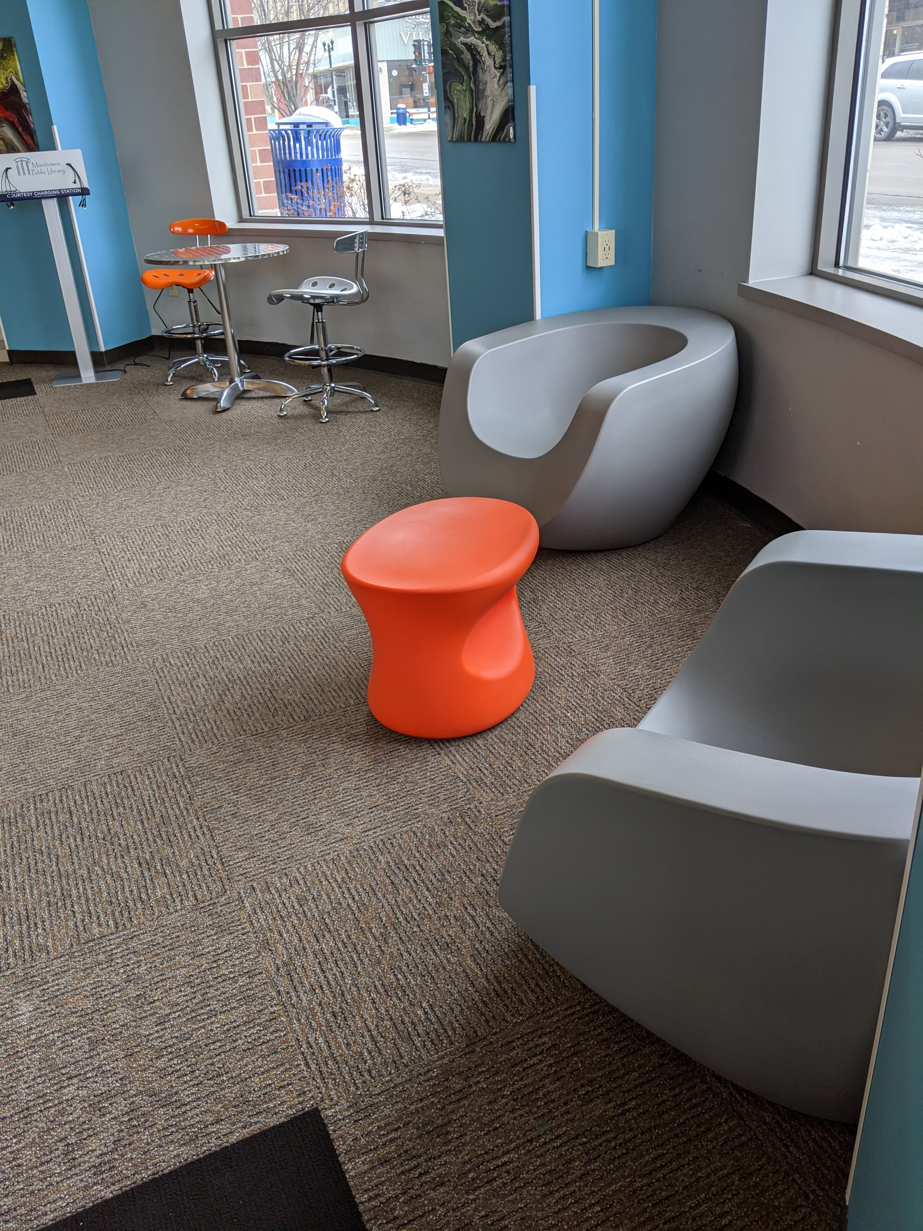 Grey and orange seating in teen space