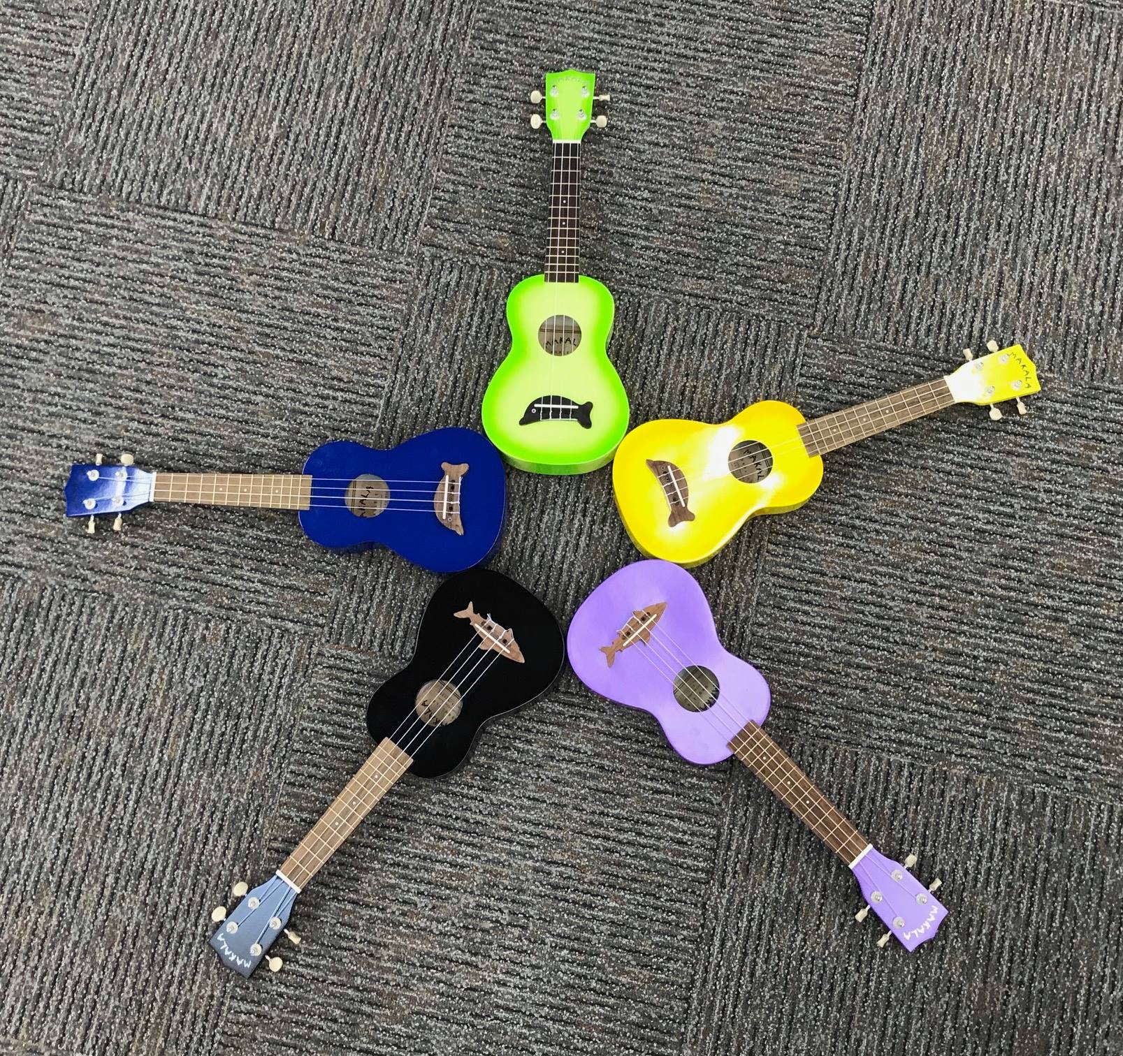 Five ukuleles arranged in star pattern