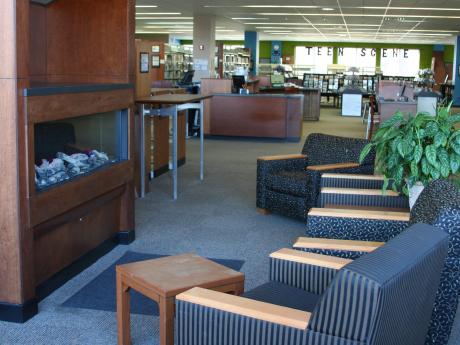 Chairs surrounding fireplace in library