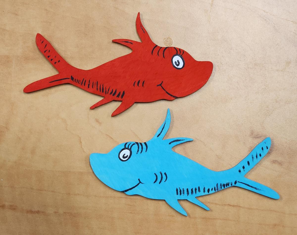 Photo of a red and a blue painted fish.